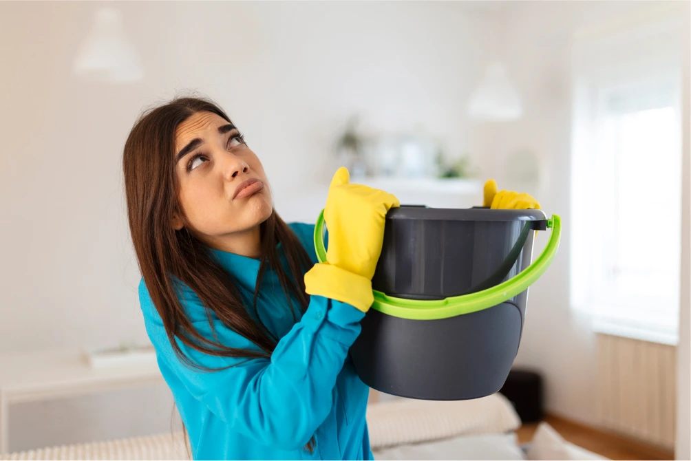 A stressful woman because her roof is leaking.